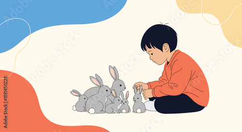 Young boy in an orange sweater crouching on the ground and gently petting one of many small gray rabbits.