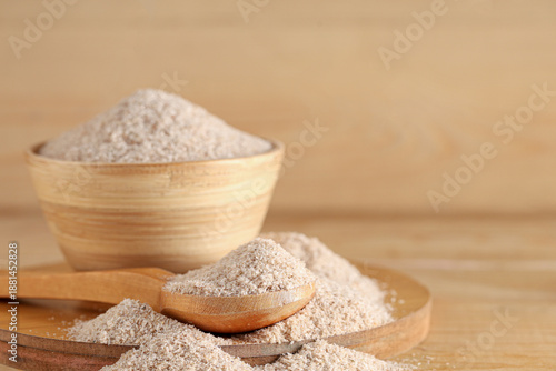 Fotografija Bowl and spoon with psyllium husk powder on wooden background