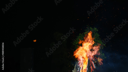 Wallpaper Mural Fire burning under a dark night sky with a red moon in the background, captured using selective focus. The image creates a mysterious and dramatic atmosphere Torontodigital.ca