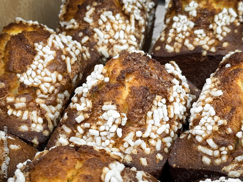 Close-up of sugar-topped cakes in a bakery display.