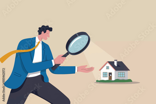 Man in a suit using a magnifying glass to carefully inspect a small house model