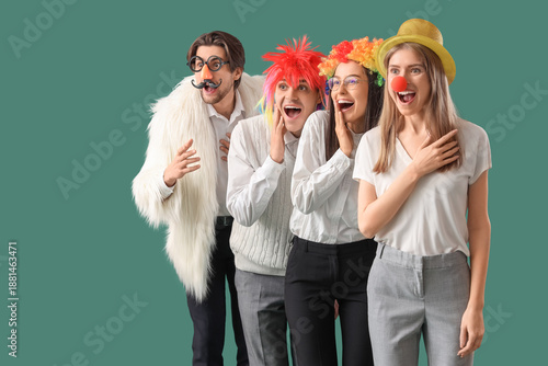 Tableau sur toile Business colleagues in funny disguise laughing on green background