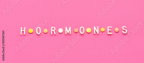 Word HORMONES on pink backg...