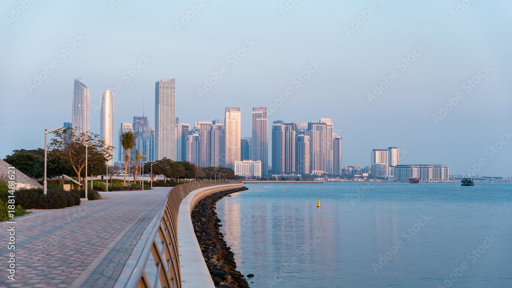 Fototapeta premium Dubai real estate background with Creek Harbor promenade and city skyline