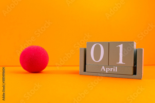 Schilderij op canvas Calendar with clown wig, funny glasses and sequins on brown background