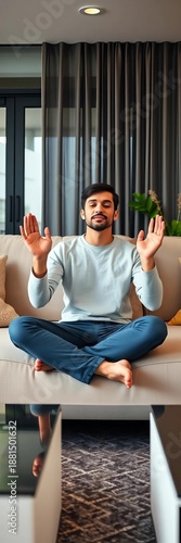 Serene individual sits, hands in OM gesture, meditating on sofa at home ,  yoga,  sofa