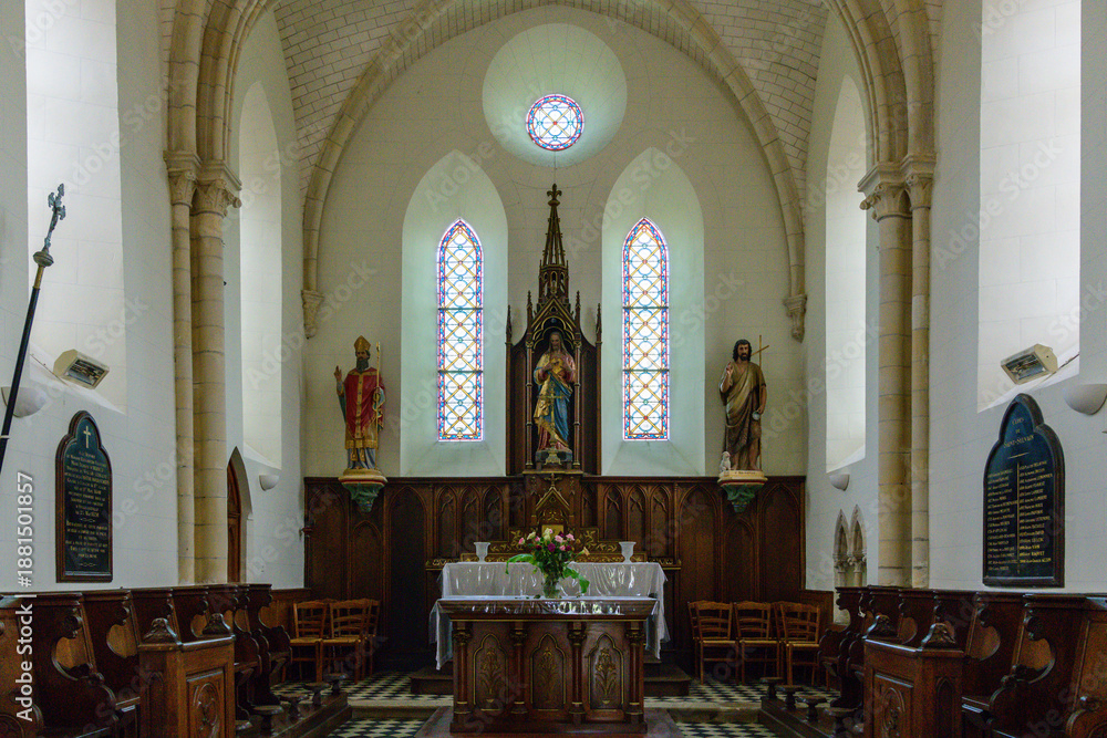 Αυτοκόλλητο Bright church chancel featuring a central altar, flanked by colorful statues and tall stained glass windows