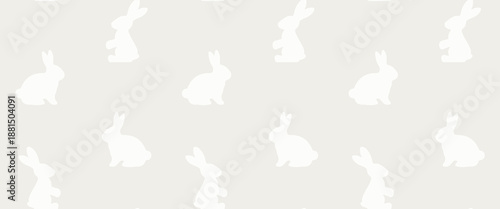 White sitting and standing rabbits on beige background. Cloud dancer - 2026 pantone colour of the year. Easter seamless pattern.
