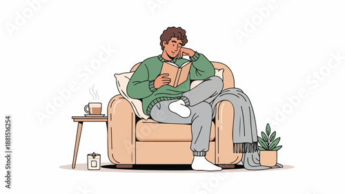 A man relaxing on a couch reading a book