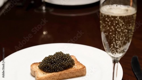 Gourmet black beluga caviar served on toast with champagne in restaurant