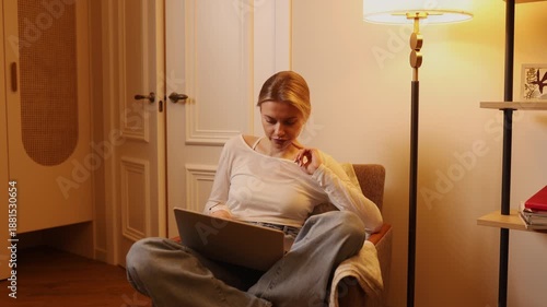 Young woman working on laptop during evening hours