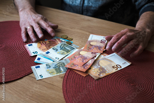 Wallpaper Mural An elderly man counts his savings.
 Torontodigital.ca
