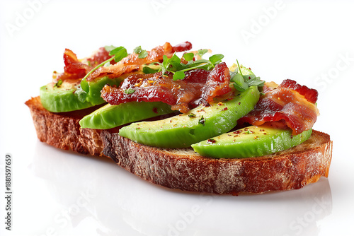 Avocado toast topped with crispy bacon slices served on toasted bread. Modern breakfast and brunch dish combining creamy avocado and savory bacon, clean studio lighting, isolated on white background.
