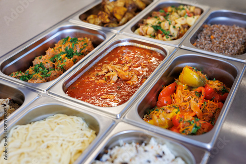 Freshly cooked delicious food in buffet serving trays at a self-service restaurant. © Studio Peace