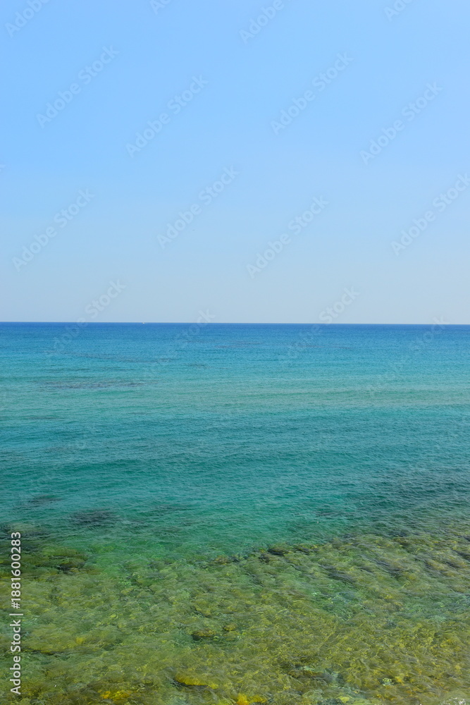 Fototapeta premium Mediterranean Sea And Rocky Coast Of Crete, Greece 21.06.2023. This was on a hot, Sunny afternoon. Clear turquoise waters of the Mediterranean Sea.