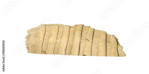 A closeup of a fresh slice of healthy whole wheat bread and a crusty brown loaf isolated on a piece of old white paper and rustic cardboard for a natural breakfast meal