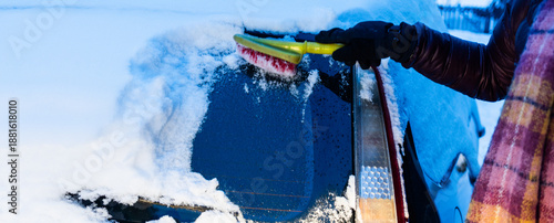 woman cleaning car from snow after snow storm