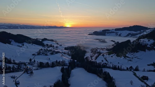 Aerial footage of sunset over the mountains and the cloud sea