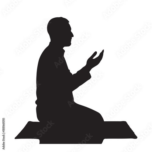 Silhouette of a muslim man kneeling on a prayer mat with hands raised in supplication