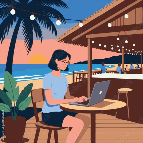 A woman works on her laptop at a beachside bar during sunset