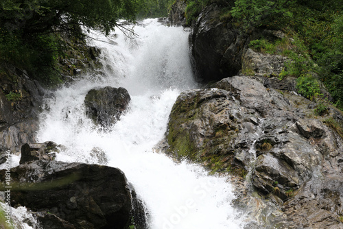 Strong flow of Chuchkhur Waterfall close up creating splashes among rocks