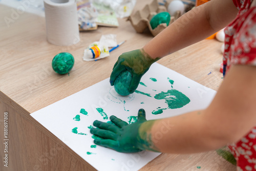 Easter egg painting with green paint for arts and crafts activity