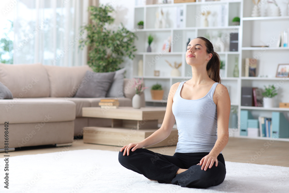 Fototapeta premium Woman breathing and meditating at home