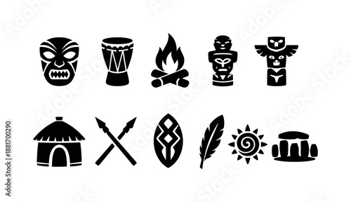 Set of black tribal symbols including carved mask, drum, campfire, totem, hut, crossed spears, shield, feather, sun and stone monument icons