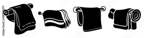 Black Towels in Various States of Fold and Roll on White Background