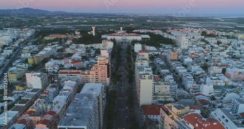 Aerial view of Faro city streets and buildings at sunset in Algarve