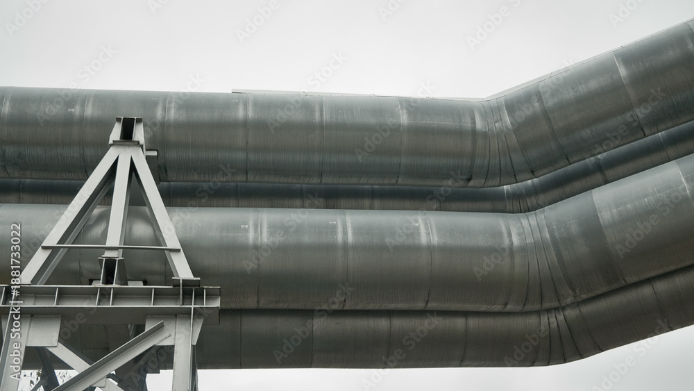 Naklejka premium close-up of a pipeline against a gray sky