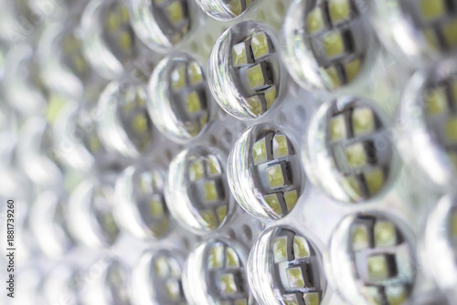 Detailed close up macro view of modern led light panel technology featuring bright silver diode array and circular electric circuit pattern creates futuristic energy efficient abstract background