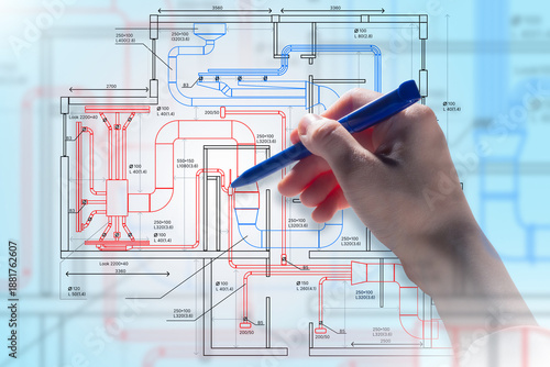 Engineering design, HVAC planning. Engineer marks ventilation and piping layout on technical blueprint, develops building systems, coordinates airflow, heating, and cooling solutions.
