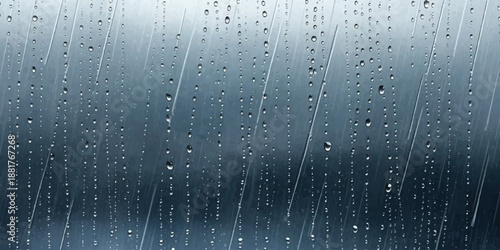 Raindrops streaming down a glass window on a moody day