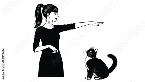 A stylish woman in a black dress directs a curious black and white cat with a pointing gesture