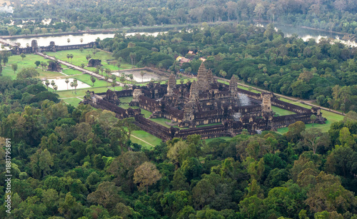 Angkor Wat temple complex aerial drone photo shows symmetrical Khmer towers, galleries and courtyards amid green lawns and jungle. Concept, quality image for editorial, tourism ads and destination use