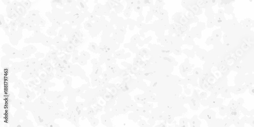 A close up view of a speckled white surface with scattered dark flecks