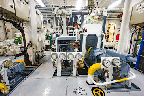 Bild auf Leinwand Marine pump system with electric motors, pressure gauges, valves and pipelines inside ship engine room, industrial ship machinery