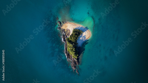Aerial view of a rugged island surrounded by turquoise waters, a hidden gem of natural beauty, Mission Beach, Queensland, Australia.