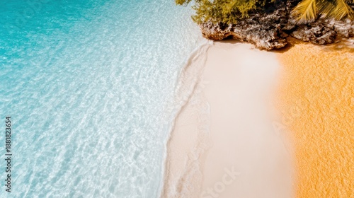 An overhead view captures the stunning contrast between a golden sandy beach and a tranquil turquoise lagoon, highlighting natural beauty and serene landscapes.
