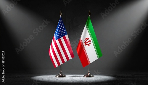 USA and Iran flags under spotlights in dark setting.