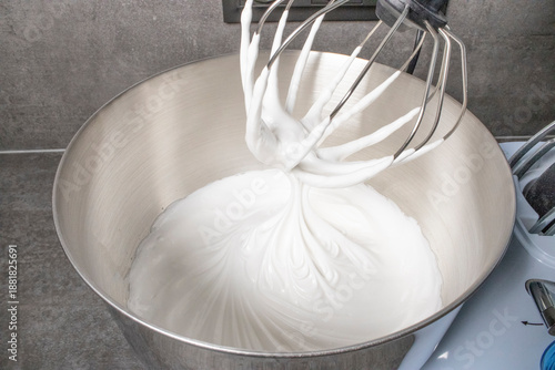 Wallpaper Mural Whipped egg whites beaten to stiff peaks, meringue preparation step captured in kitchen, airy texture forms base for classic meringue roll. Torontodigital.ca