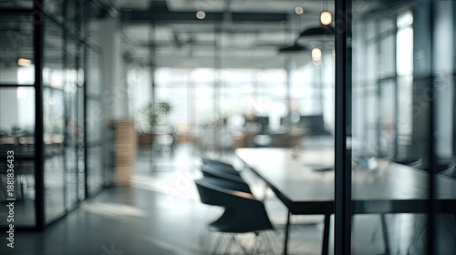 Modern office interior featuring glass walls, desks, chairs, and natural light