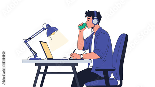 Young creative male professional listens to music and drinks coffee while working on laptop at his desk.