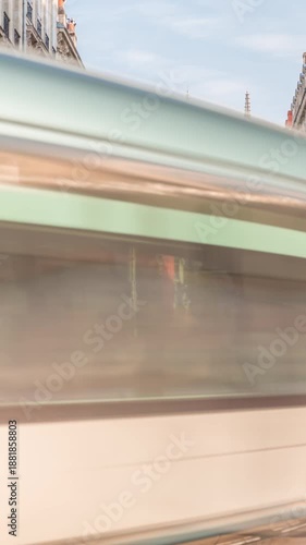 Timelapse of Bordeaux Cathedral (Cathedrale Saint Andre) from Vital Carles street, featuring a moving tram in the historic city. People wait at the tram stop. A symbol of Bordeaux's heritage. France