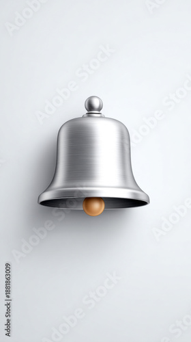 A sleek, silver bell hangs against a minimalist background, showcasing its polished surface and simple design.