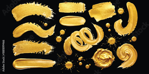 Set of golden metallic paint brush strokes, smudges, swirls, and splatters isolated on black background