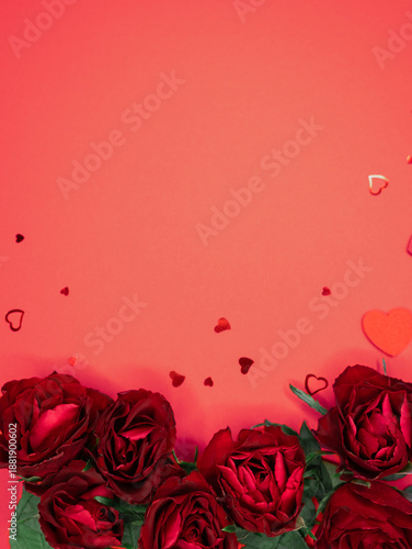 Beautiful and festive background for valentines day or anniversary celebration in pink with pink present and red ribbons roses and copy space 