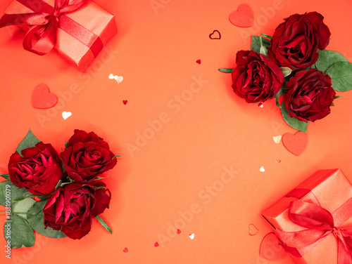 Beautiful and festive background for valentines day or anniversary celebration in pink with pink present and red ribbons roses and copy space 