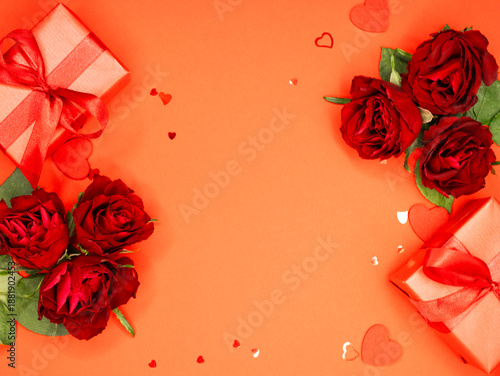 Beautiful and festive background for valentines day or anniversary celebration in pink with pink present and red ribbons roses and copy space 